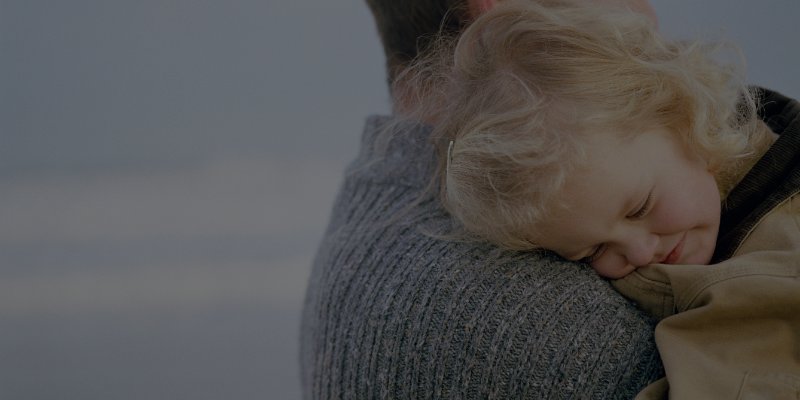 Father holding daughter on his shoulder